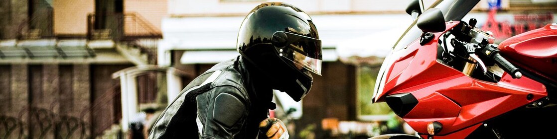 Person looking at his motorcycle