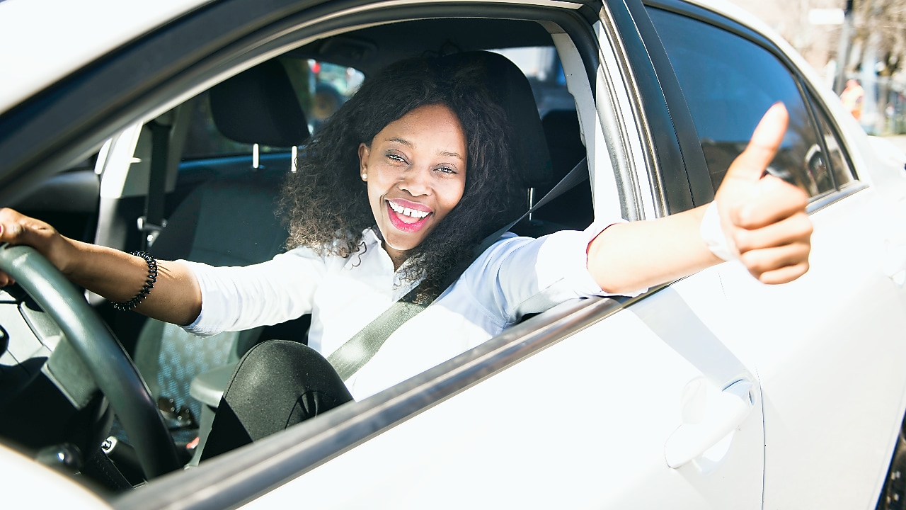 Happy women sitting in white car